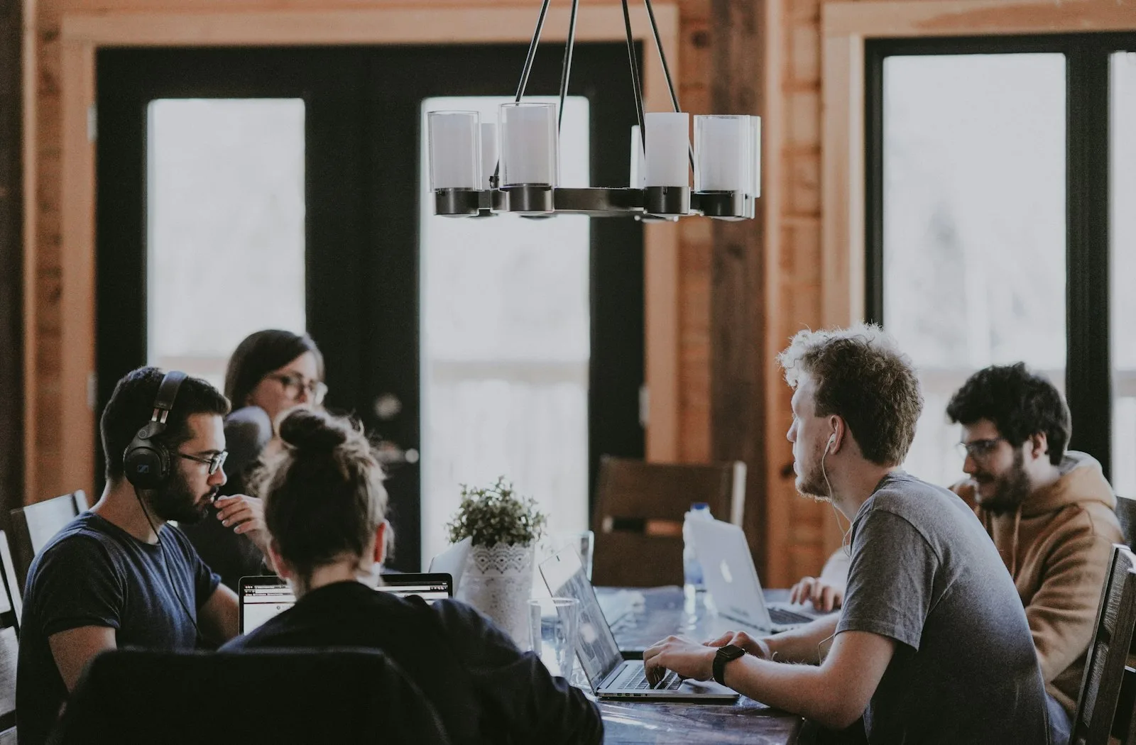 A team working together at laptops around a table